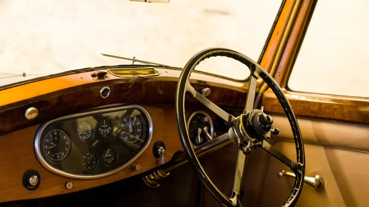 A vintage wood dashboard and steering wheel