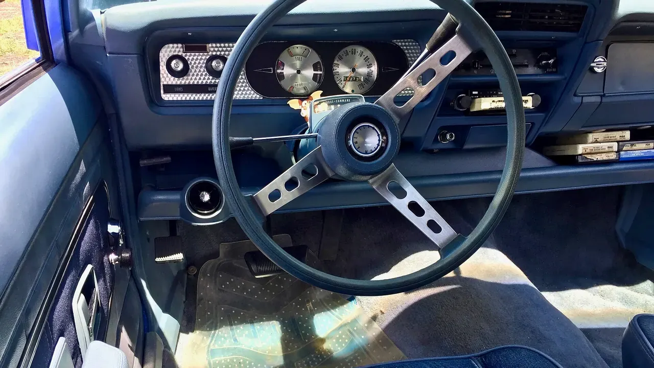 The black dashboard and front seats of a classic car