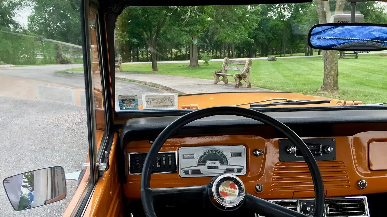 A vintage dashboard viewed from the driver's seat