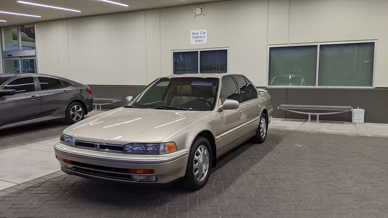A newly delivered sedan displayed in a delivery area