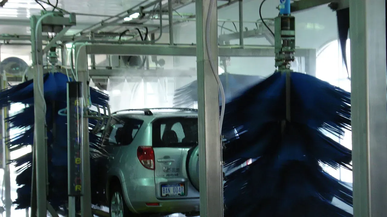 A vehicle traveling through an automatic car wash