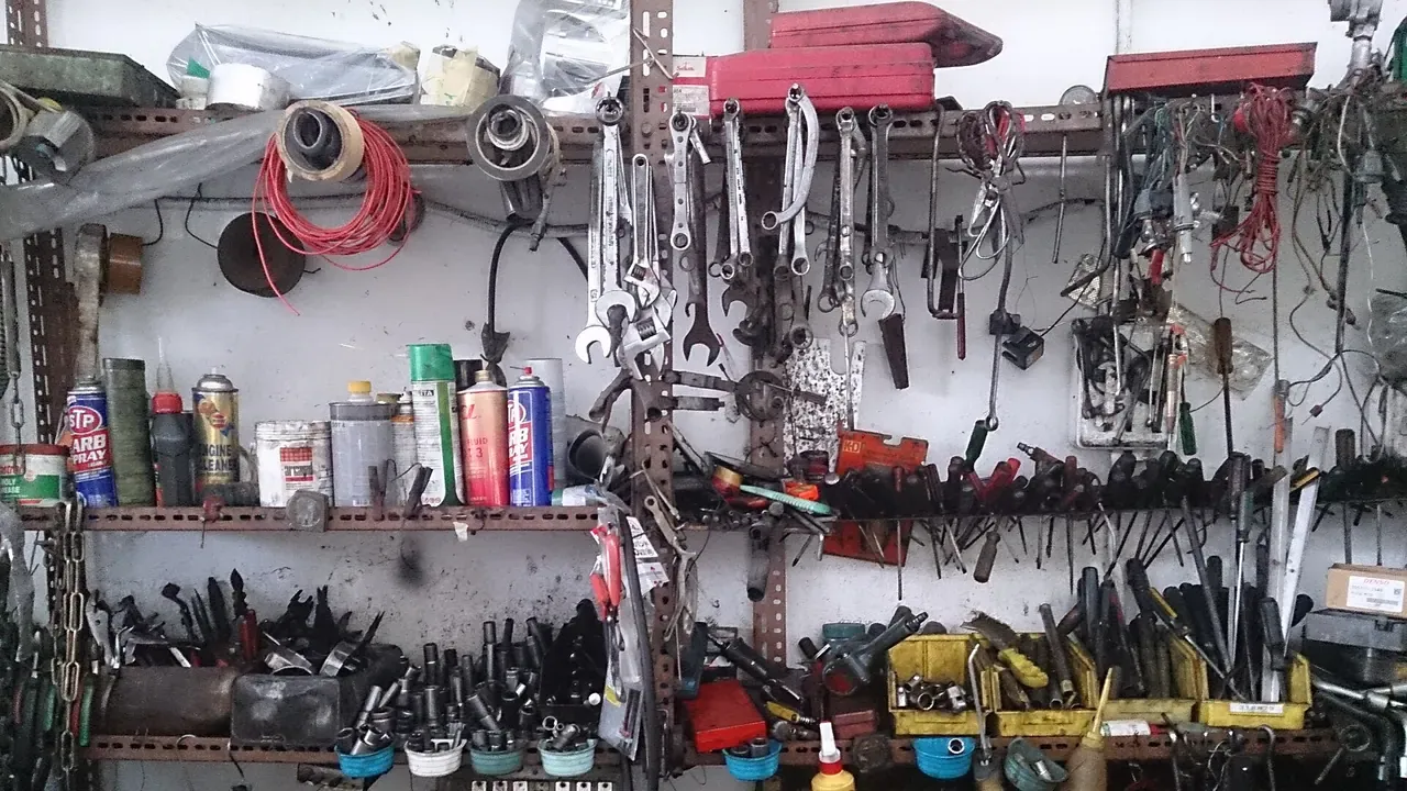 Shelves, tools, and equipment inside a busy car workshop