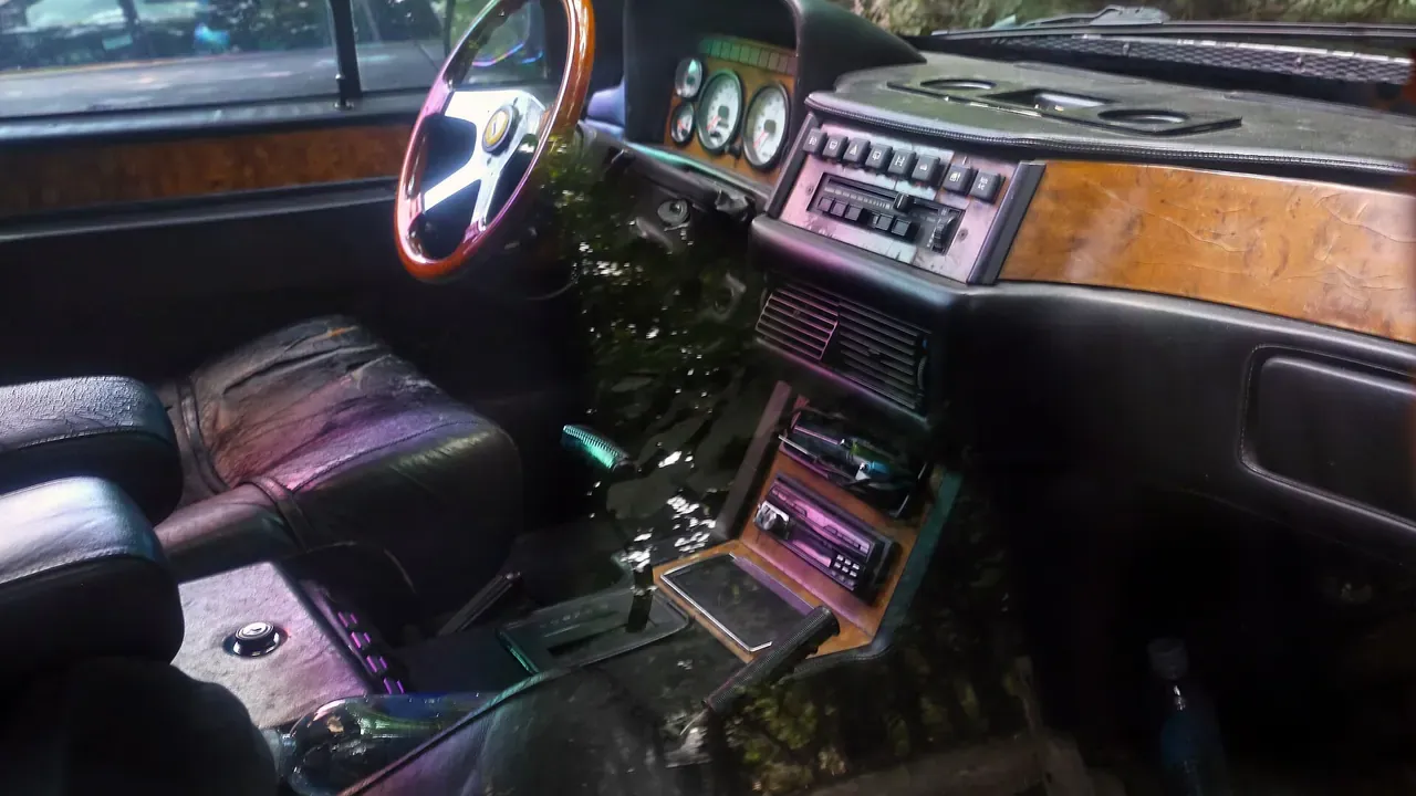 A brown dashboard and front seats inside an older vehicle