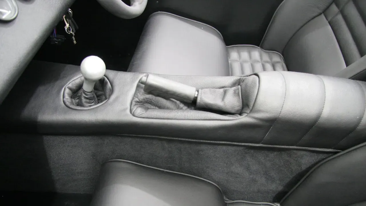 Black leather seats and a center console inside a sports car